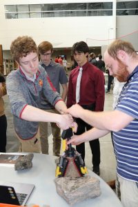 Students demonstrate the NASA Micro-G NExT team's device