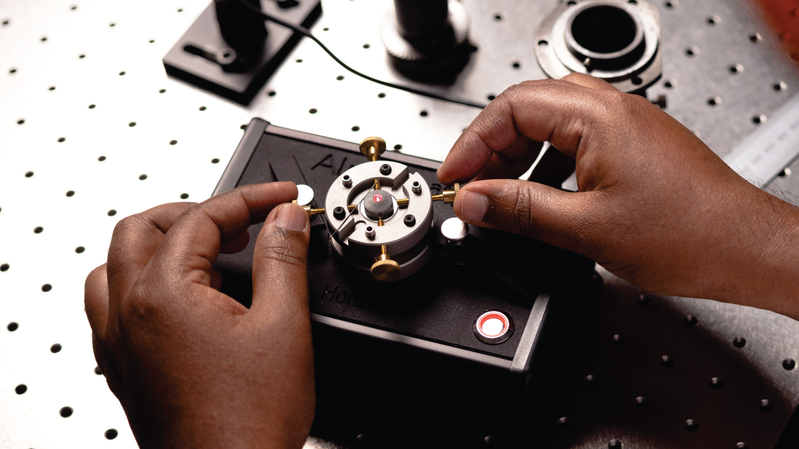 Hands working on a lab component