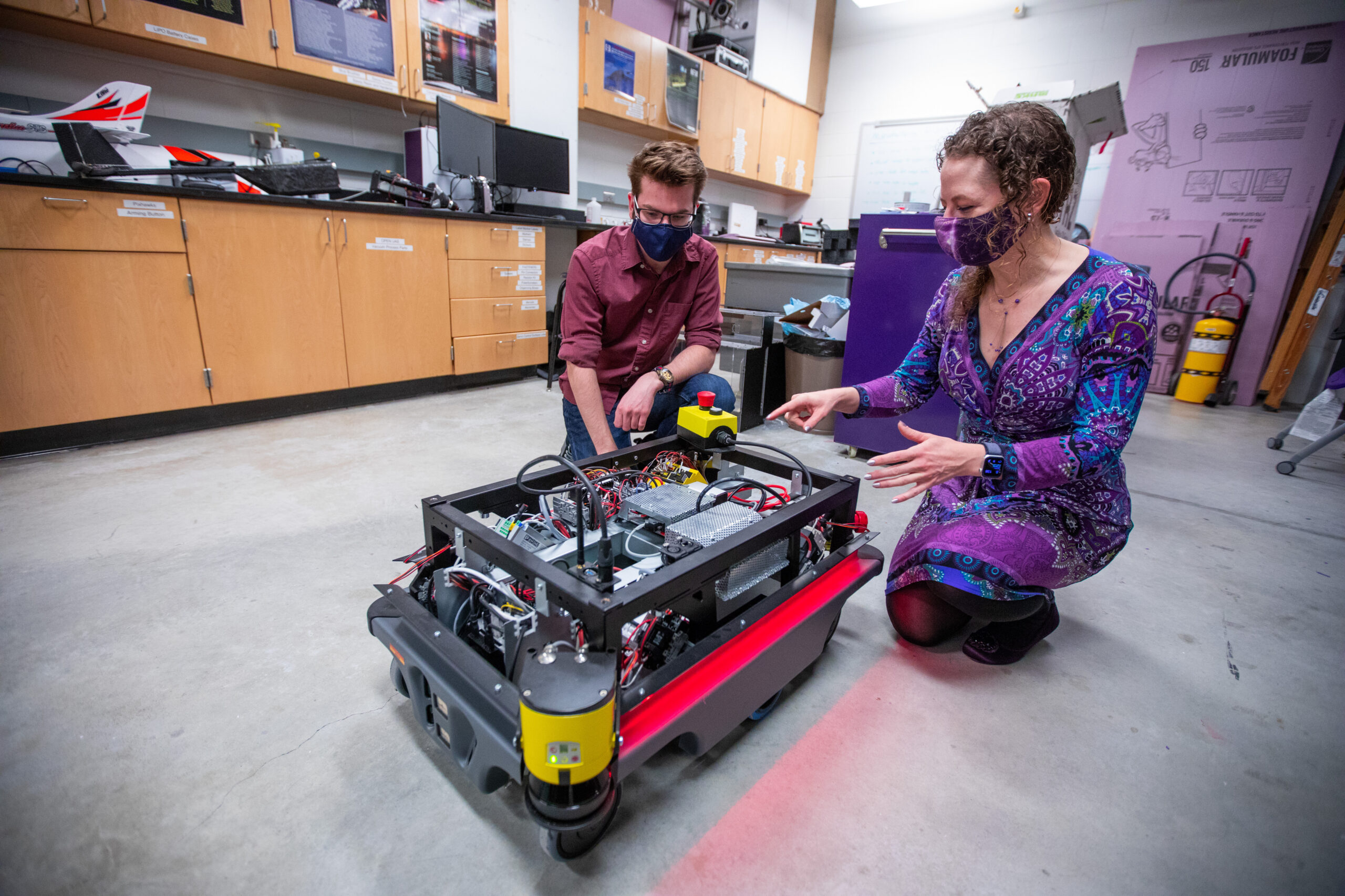 Dr. Rozier and student working on mechanical component in lab