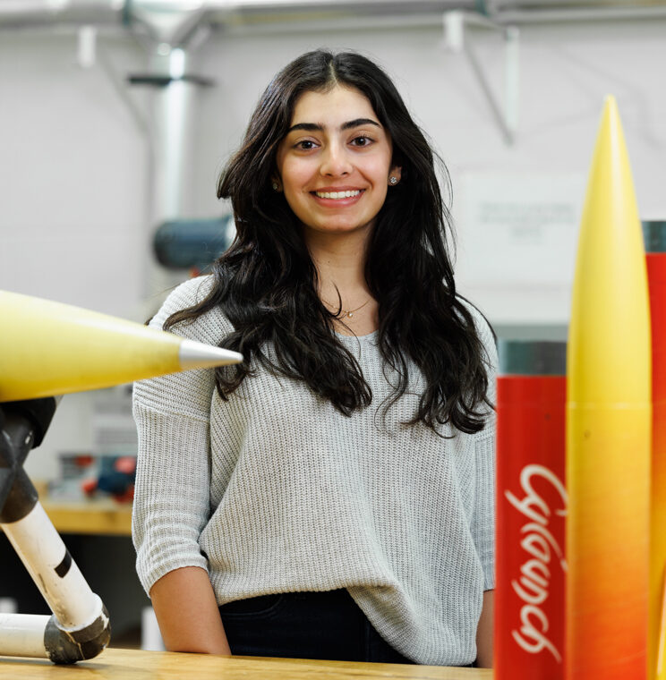 Khushi Kapoor stands by her rockets at the Iowa State Department of Aerospace Engineering